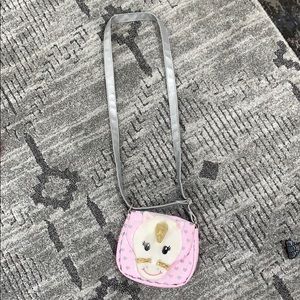 A pink unicorn hang bag with hearts
